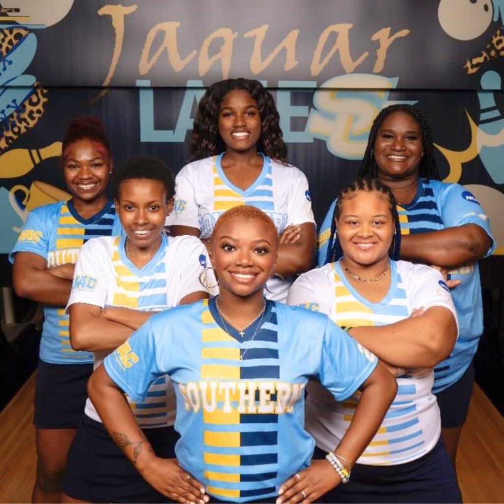 Six members of the Southern University bowling team pose in a triangle formation, all wearing their uniforms and smiling. 