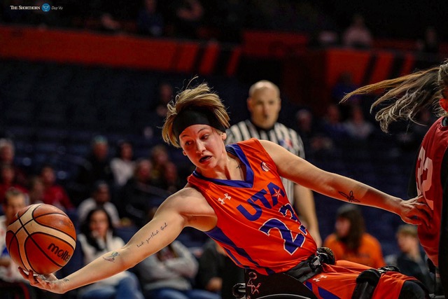 Abby Dunkin making a very athletic play while playing Wheelchair Basketball.