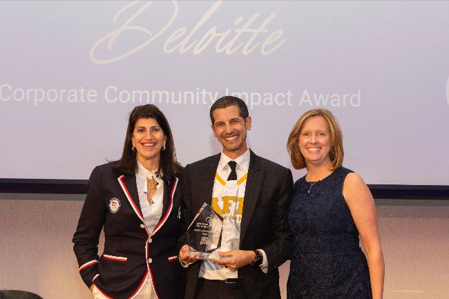 Lara Abrash and Kathleen Purtill pose around Jason Belinkie after Jason presented Deloitte with their award.