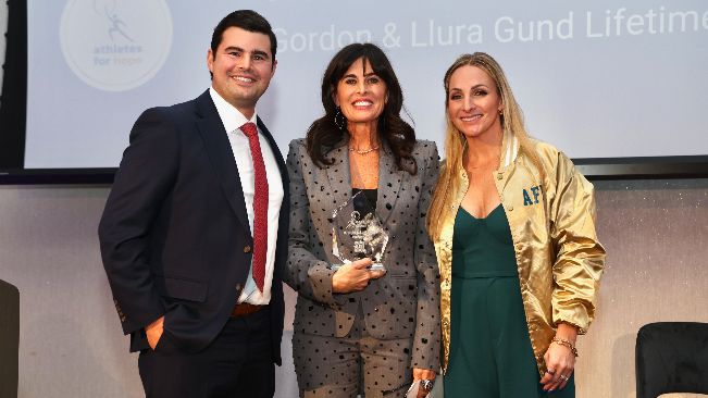 Michelle Freeman poses between Nick Freeman and Christin Blyumin after accepting her award. 